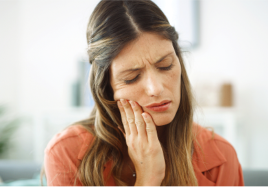 Patient holding their jaw with dental pain